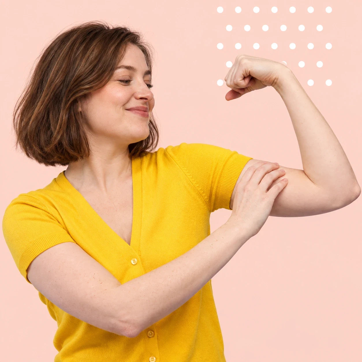 A woman in yellow admiring her flexed arm